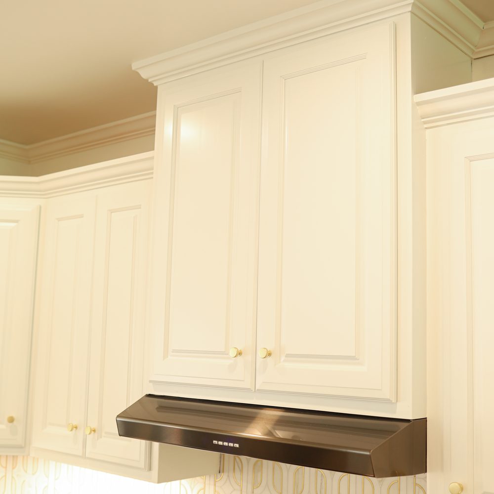 Detail: hand-finished cabinet door and range hood joinery