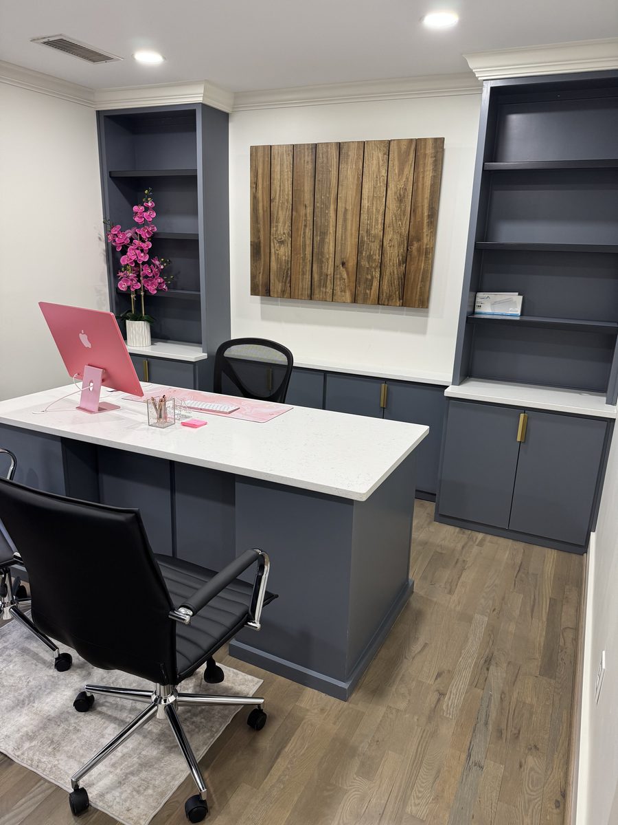 Custom navy built-in office cabinetry with brass hardware