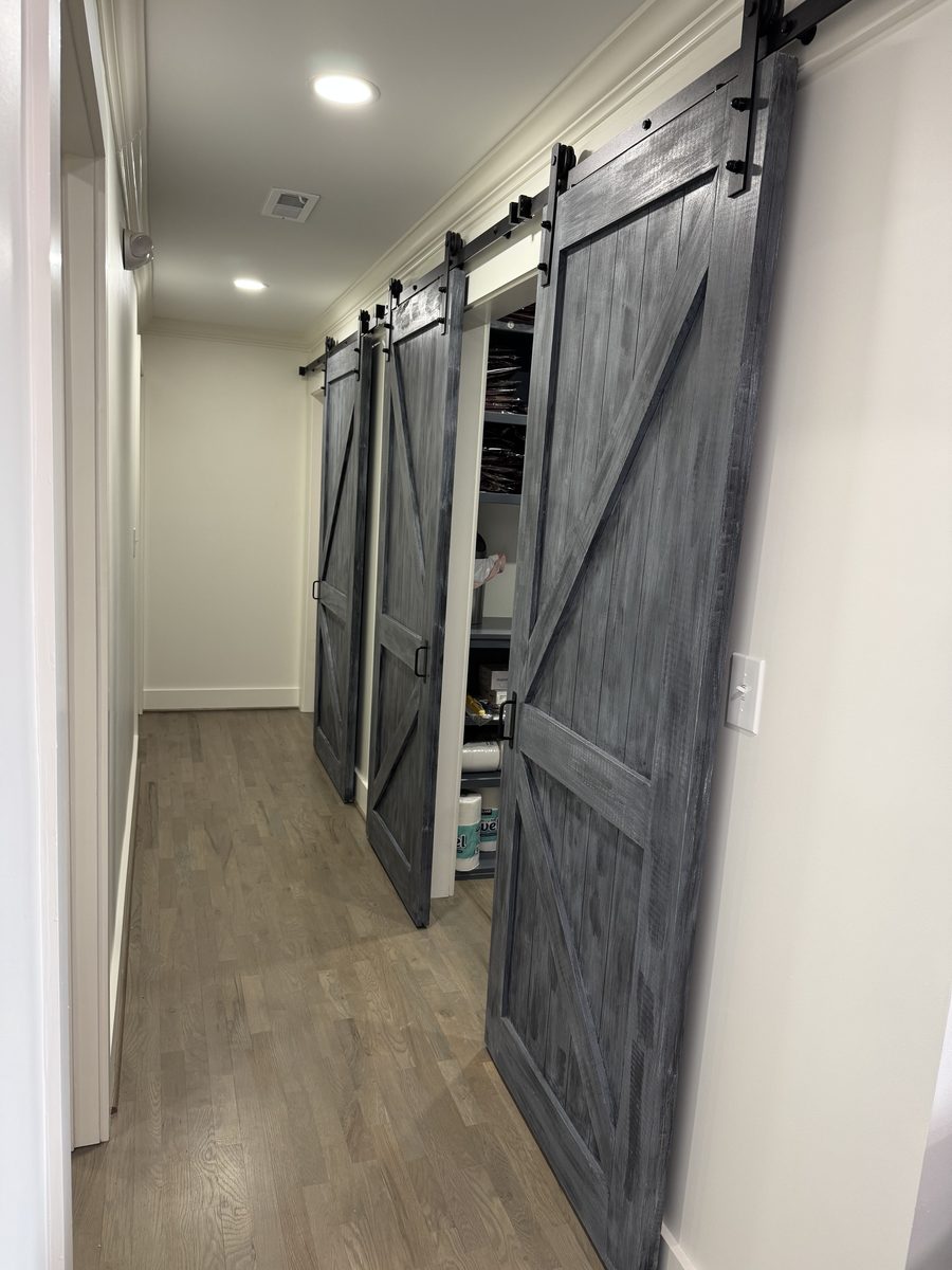 Custom sliding barn-door built-in storage wall